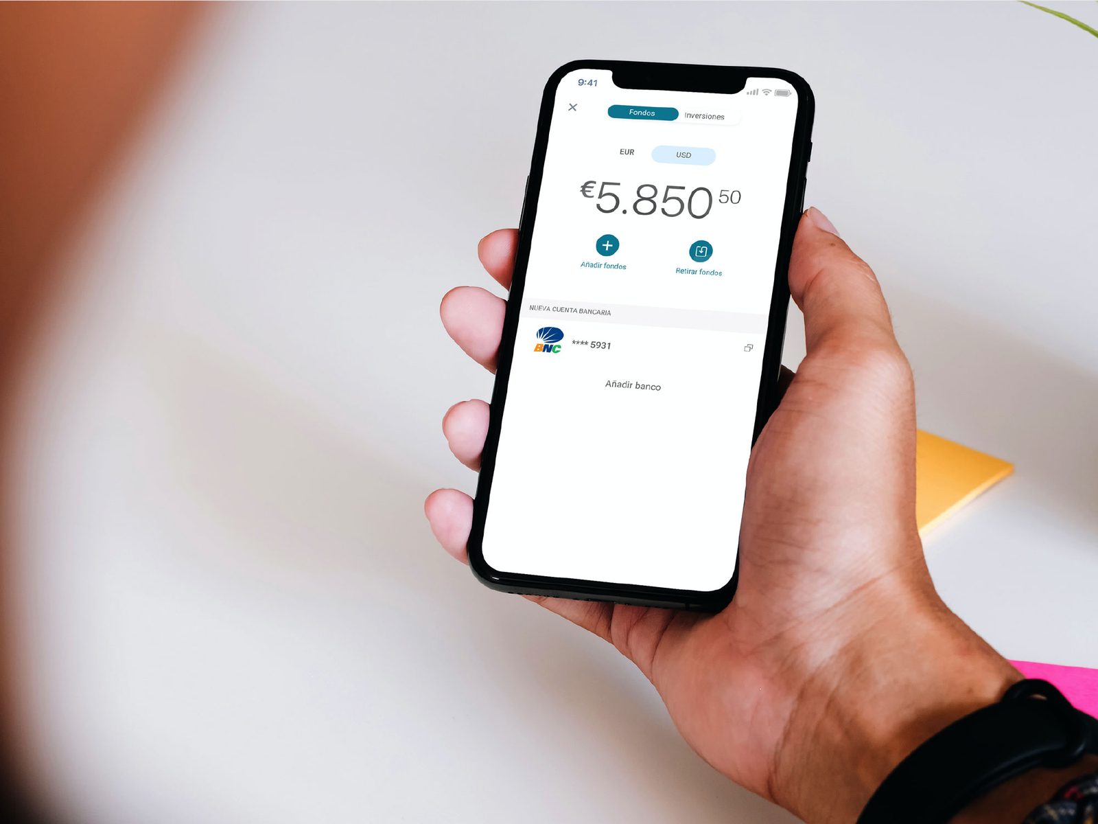 Shasta app funds screen with bank account linked, held in hand